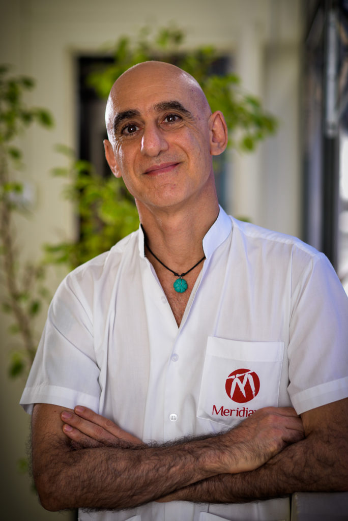 Practitioner in clinic uniform with smiling and kind face